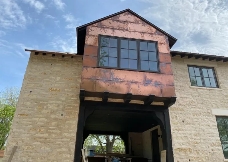 Copper metal panel facade on a stone building for Roof Repair in Dearborn Heights