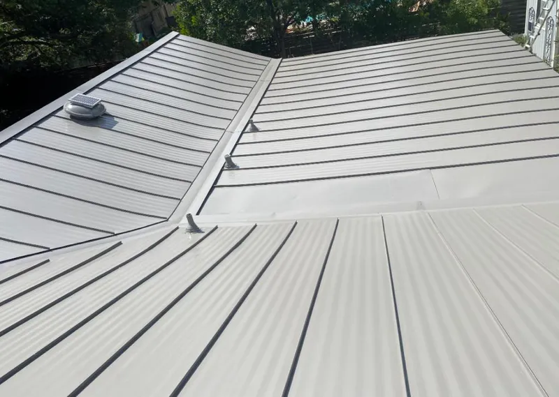 Solar attic fan installed on a metal roof for Roof Ventilation in Dearborn Heights